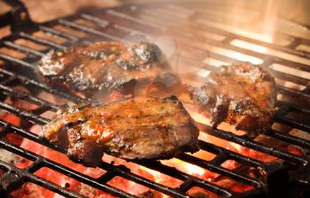 Grilling marinated meat on a charcoal grill
