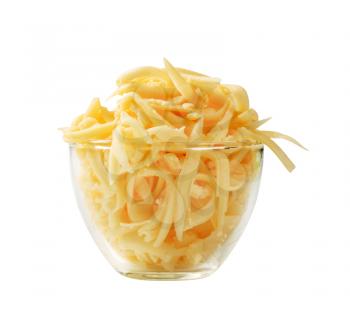 Grated yellow cheese in a glass cup