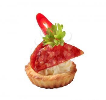 Tartlet shell filled with cream cheese and salami