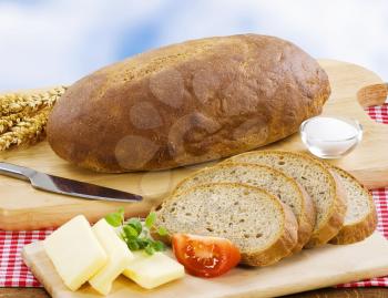 Loaf of bread, salt and butter - still life