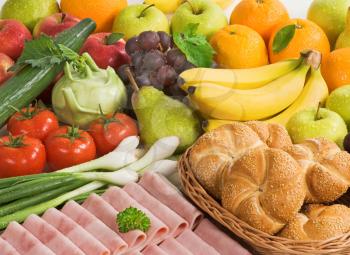 Fresh fruit and vegetables, rolls and slices of ham