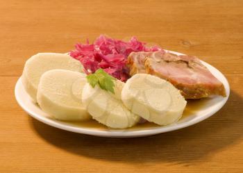 Roast pork, potato dumplings and red cabbage 