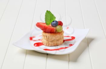 Custard filled puff pastry shell topped with berry fruit