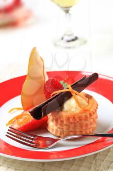 Cream filled puff pastry shell garnished with fresh fruit