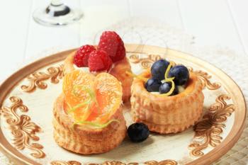 Custard filled puff pastry cases topped with fresh fruit
