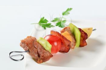 Pork skewer with pieces of pepper and bacon