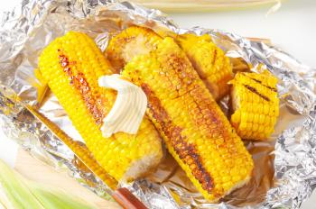 Pieces of sweet corn grilled in tin foil