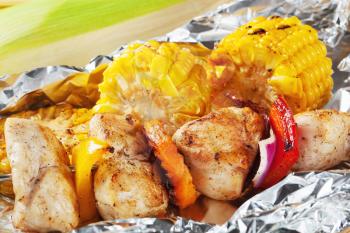 Shish kebab and grilled corn on tinfoil