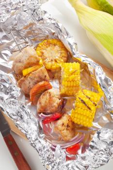Shish kebab and grilled corn on tinfoil
