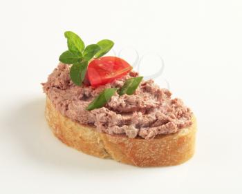 Slice of toasted bread and meat spread