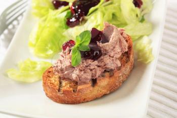 Toasted bread and pate with cranberry sauce and lettuce