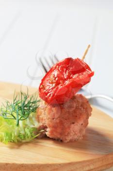 Meatball and tomato on a cocktail stick