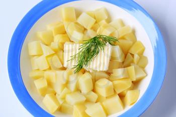 Plate of diced potatoes with fresh butter
