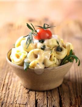 Bowl of tortellini with cheese sauce
