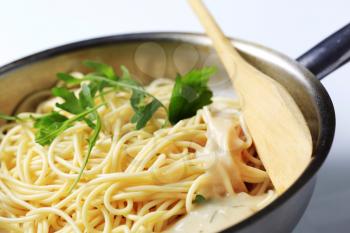 Spaghetti and creamy sauce in a saucepan