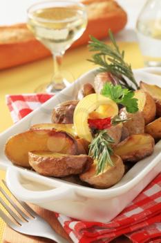 Halves of baked potatoes in a casserole dish