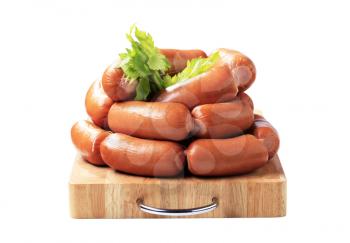 Pile of sausages on cutting board