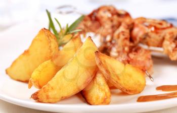 Baked potato wedges and roast meat rolls