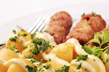 Cevapcici with potatoes, mayonnaise and chopped parsley