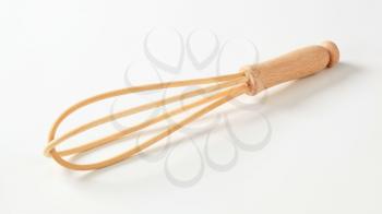 Closeup of wooden cooking whisk - studio