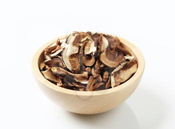 Dried mushrooms in a wooden bowl - studio