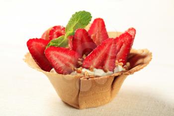 Pastry cup filled with cream and fresh strawberries