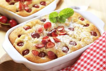 Freshly baked cherry sponge cake in a porcelain casserole dish