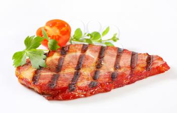 Slice of grilled pork neck on white background