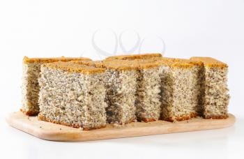 Slices of poppy seed cake on cutting board