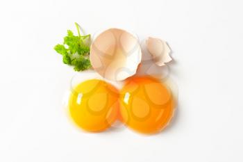 Two fresh egg yolks and empty half an eggshell