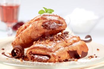 Pains au chocolat sprinkled with chopped nuts