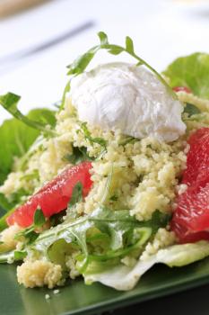 Couscous with red orange and rocket, poached egg on top