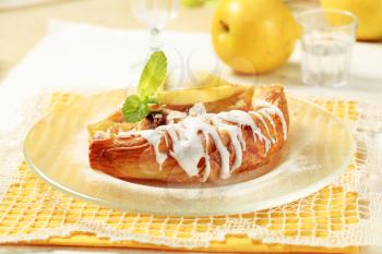 Danish pastry with apple filling and sugar icing 