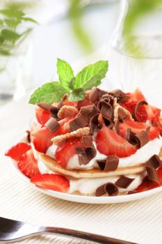 Pancakes with cheese, strawberries and chocolate curls