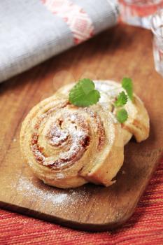 Sweet pastry rolls with nut filling dusted with icing sugar