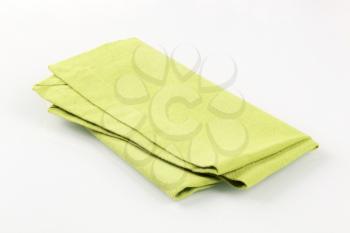 Green folded textile table napkin
