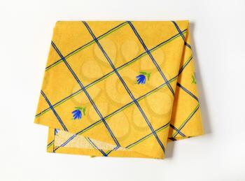 Small yellow napkin with flower pattern