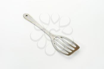 Metal spatula used for turning, lifting and transferring foods when cooking