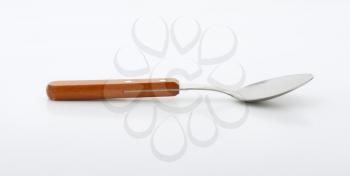 Empty table spoon with wooden handle