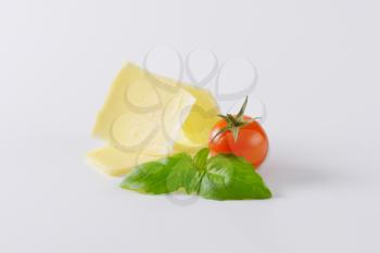 thin slices of parmesan cheese, cherry tomato and basil