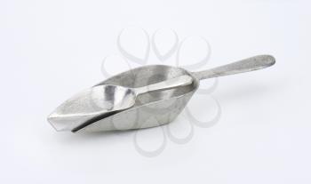 two empty metal scoops on white background