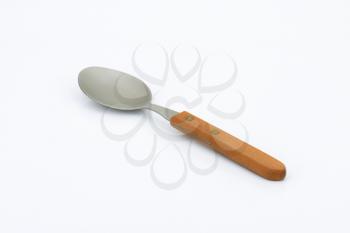empty spoon with wooden handle on white background