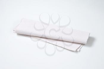 folded white cloth place mat
