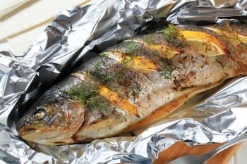 Trout stuffed with lemon and dill, baked in tin foil