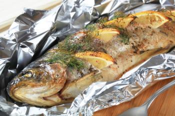 Trout stuffed with lemon and dill, baked in tin foil