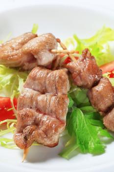 Grilled pork tenderloin on nest of salad greens