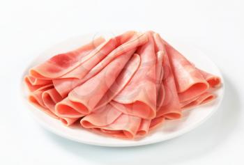 Thinly sliced ham on a plate