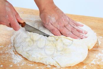 Cook making yeast pizza dough