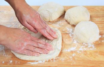 Man's hands preparing pizza dough