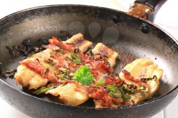 Pan fried fish fillets with bacon and spring onion